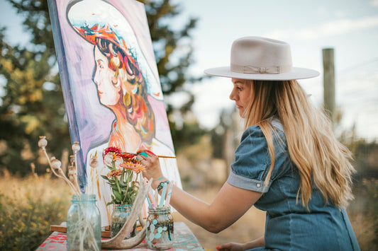 Western Artist Tirzah Lane Art creating a cowgirl painting