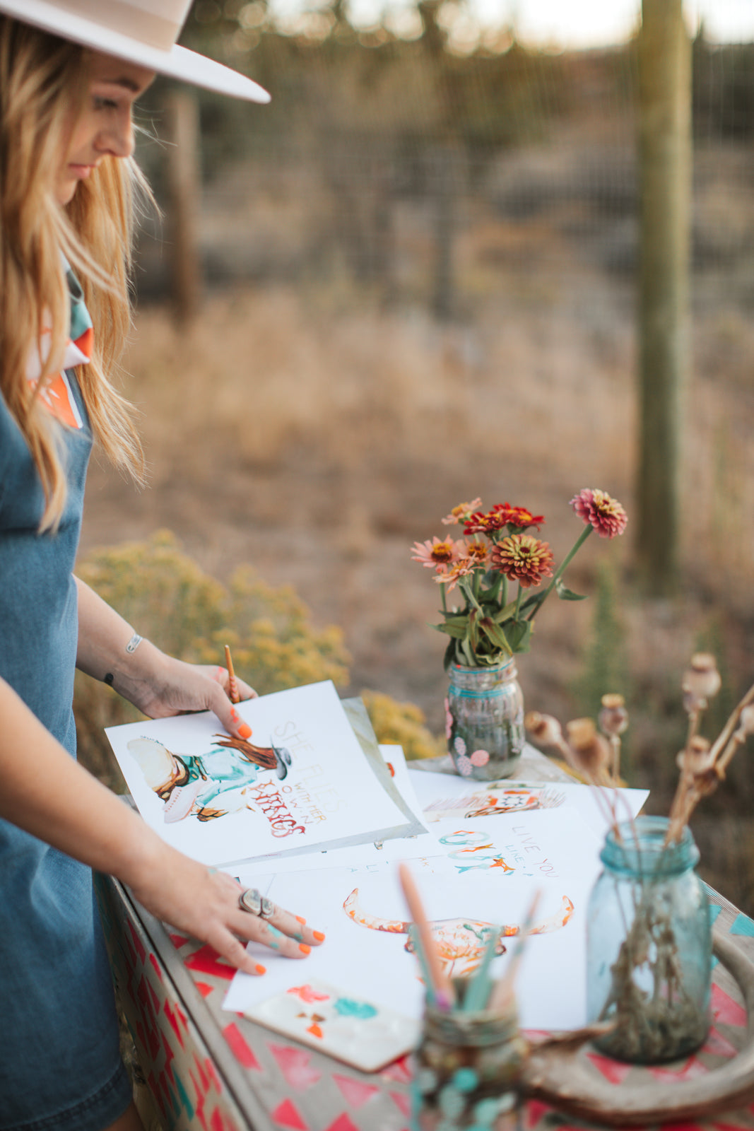 Western women artist working on rodeo cowgirl western art